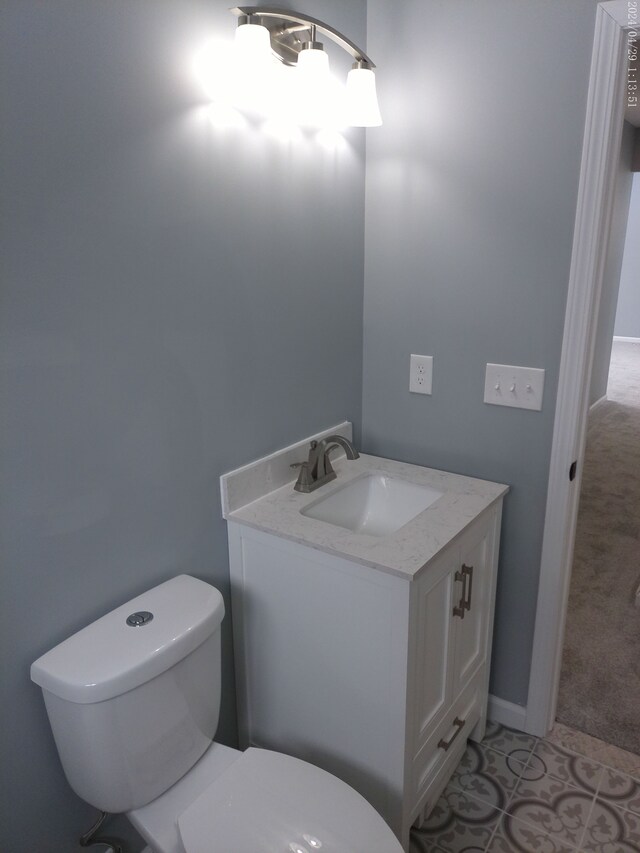 bathroom featuring tile patterned flooring, vanity, and toilet