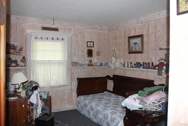 bedroom with wood walls