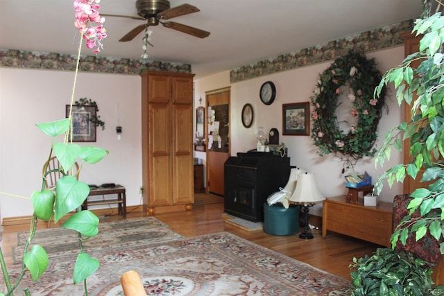 living room with ceiling fan and wood-type flooring