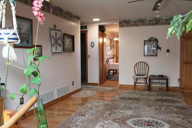 interior space with wood-type flooring and ceiling fan