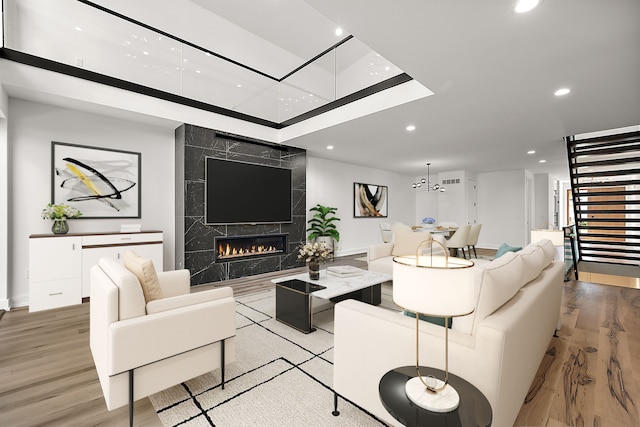 living room with a high end fireplace and light wood-type flooring