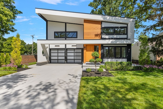 contemporary house featuring a garage and a front lawn