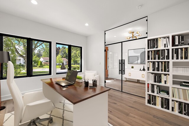 office space with light wood-type flooring and recessed lighting