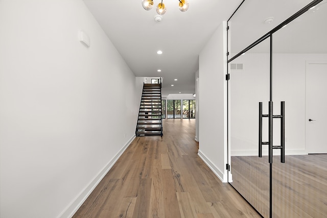 hallway with light hardwood / wood-style flooring