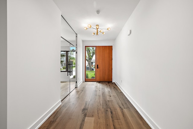 entryway featuring a chandelier and wood-type flooring