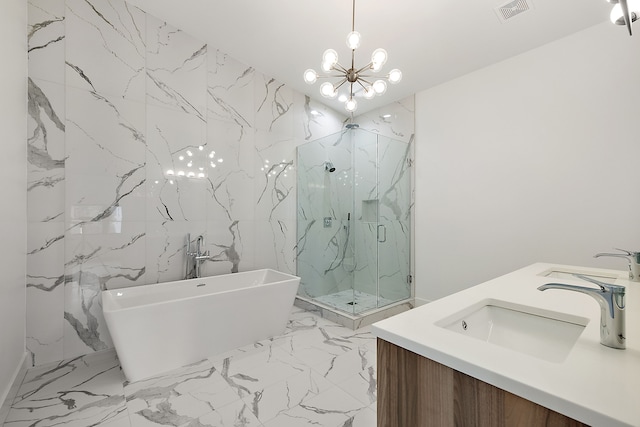 bathroom with vanity, tile walls, plus walk in shower, and an inviting chandelier