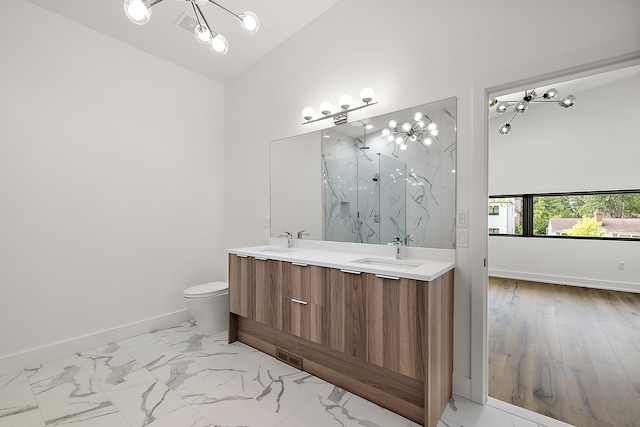 full bathroom with lofted ceiling, marble finish floor, a sink, and baseboards