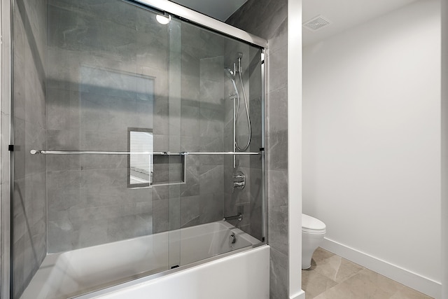 bathroom featuring toilet, shower / bath combination with glass door, visible vents, and baseboards