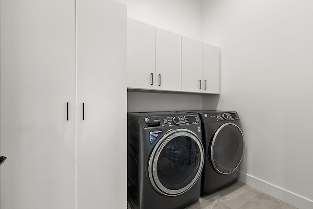 laundry area with cabinets and separate washer and dryer