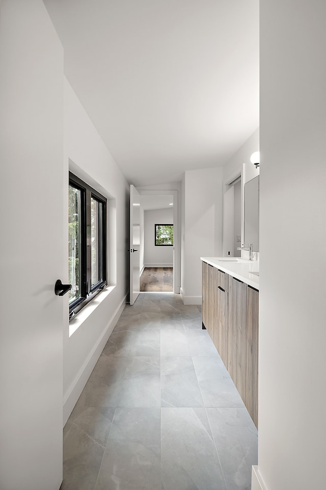 bathroom with baseboards and vanity