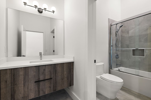 full bathroom featuring vanity, bath / shower combo with glass door, and toilet