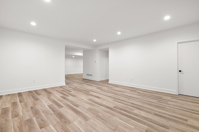 interior space featuring recessed lighting, visible vents, light wood-style flooring, and baseboards