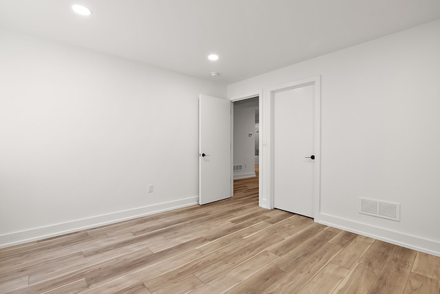 empty room with baseboards, recessed lighting, visible vents, and light wood-style floors