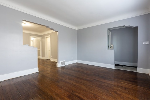 spare room with crown molding and dark wood-type flooring