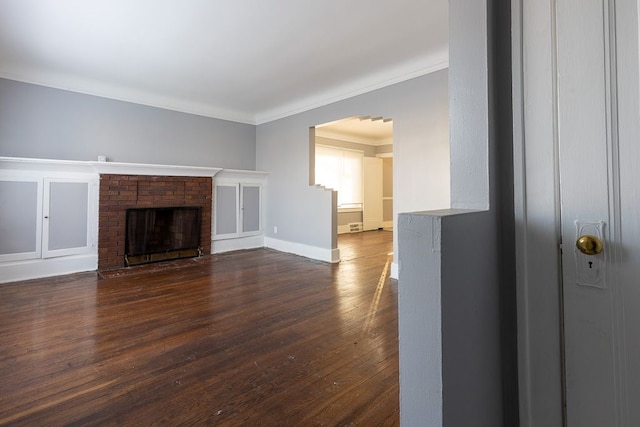 unfurnished living room with ornamental molding, dark hardwood / wood-style floors, and a brick fireplace