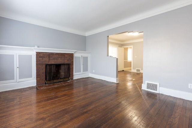 unfurnished living room featuring a fireplace, ornamental molding, and dark wood-type flooring