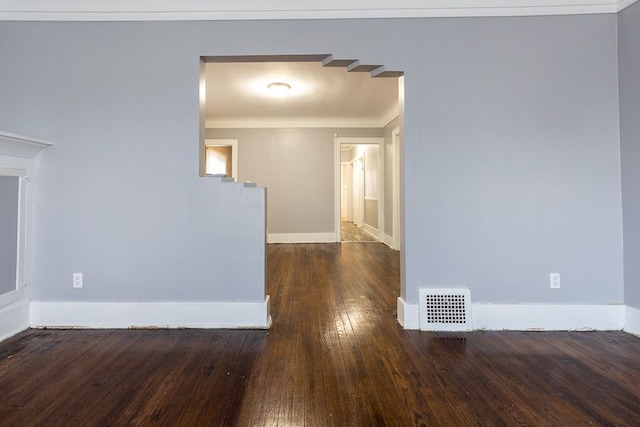 spare room with dark hardwood / wood-style flooring and ornamental molding