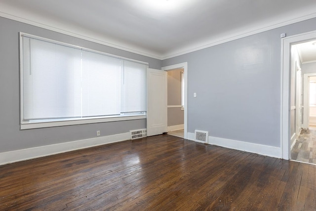 unfurnished room featuring ornamental molding and dark wood-type flooring