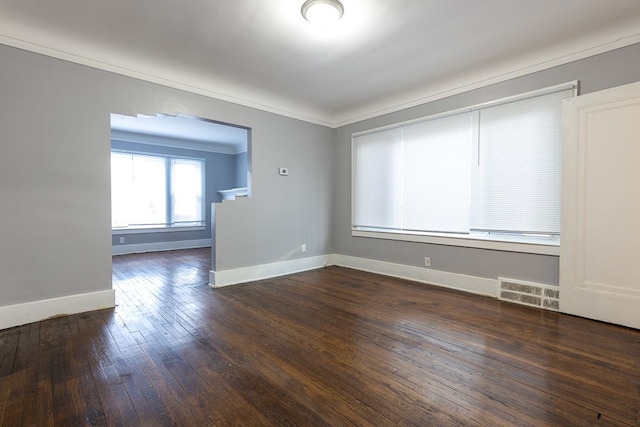 spare room featuring dark hardwood / wood-style flooring and ornamental molding