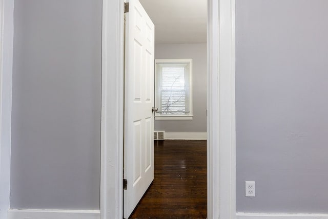 hall with dark wood-type flooring