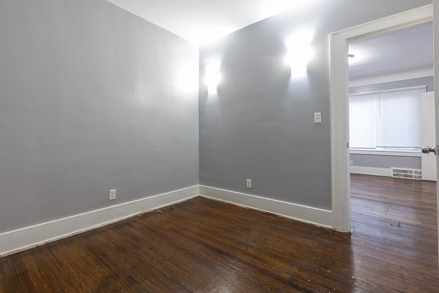 empty room featuring dark hardwood / wood-style flooring