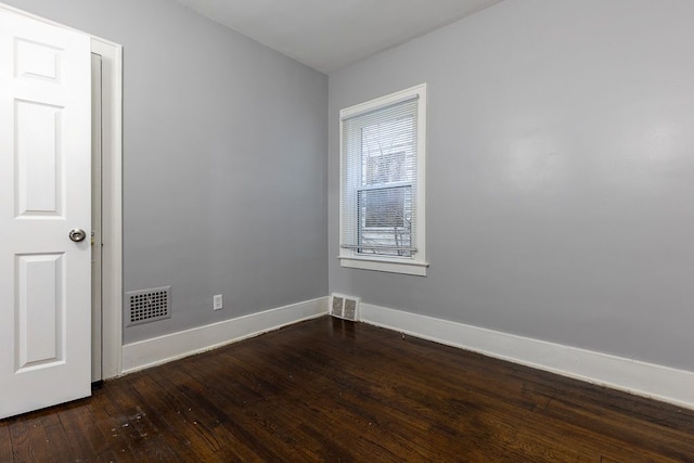 spare room featuring dark hardwood / wood-style floors