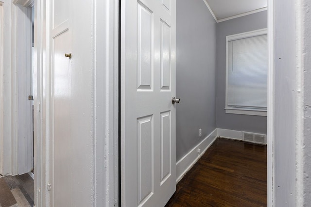 corridor featuring dark hardwood / wood-style flooring and ornamental molding