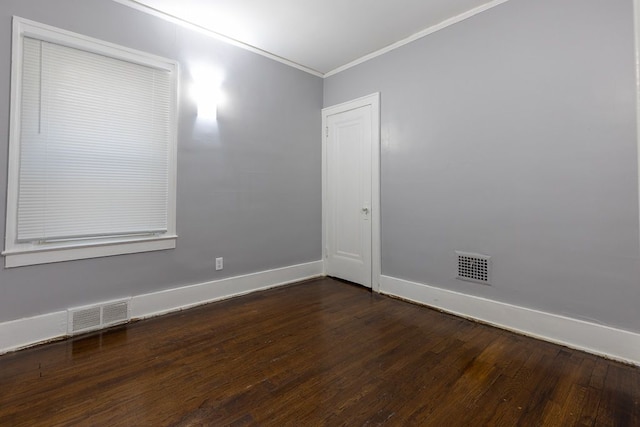 unfurnished room featuring dark wood-type flooring and ornamental molding