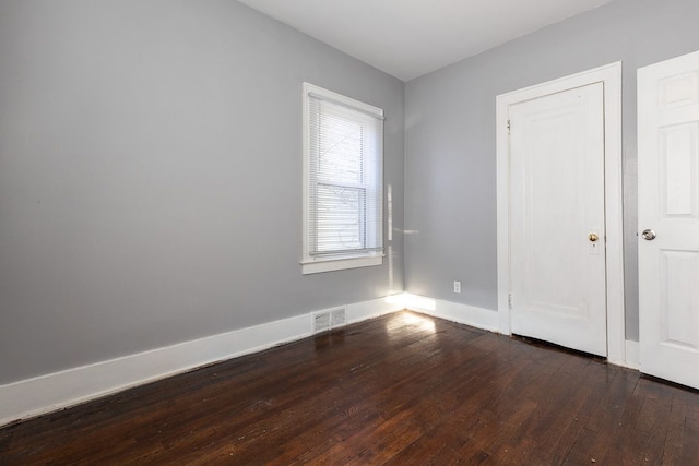 unfurnished bedroom featuring dark hardwood / wood-style flooring