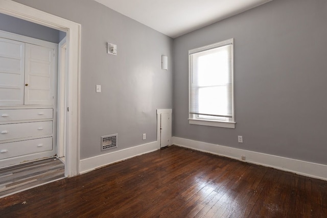 spare room with dark hardwood / wood-style floors