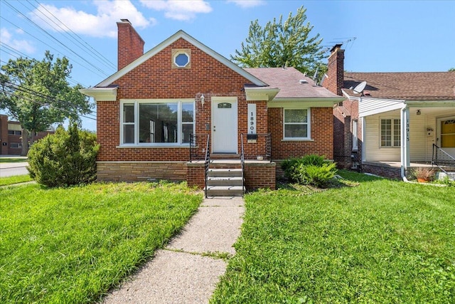 bungalow-style house featuring a front yard