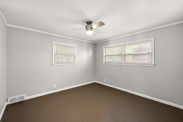 spare room with dark carpet, ceiling fan, and crown molding