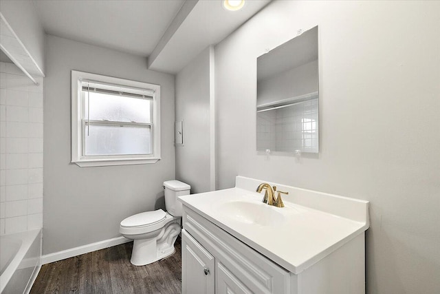 full bathroom with vanity, toilet, wood-type flooring, and tiled shower / bath