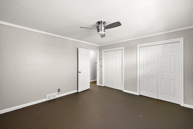 unfurnished bedroom featuring ceiling fan, crown molding, and two closets