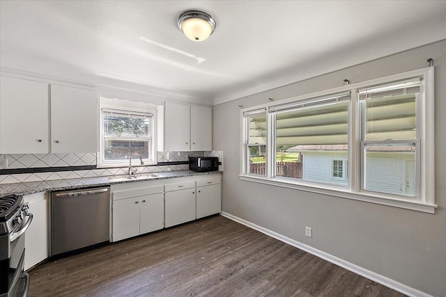 kitchen featuring sink, stainless steel appliances, dark hardwood / wood-style floors, backsplash, and white cabinets