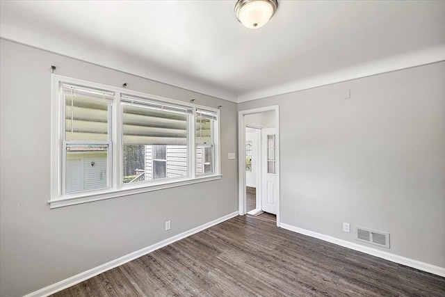 empty room featuring dark hardwood / wood-style flooring