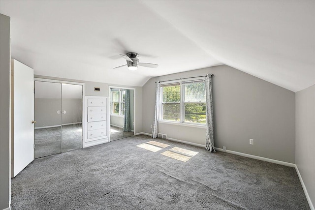 bonus room featuring ceiling fan, lofted ceiling, and dark colored carpet