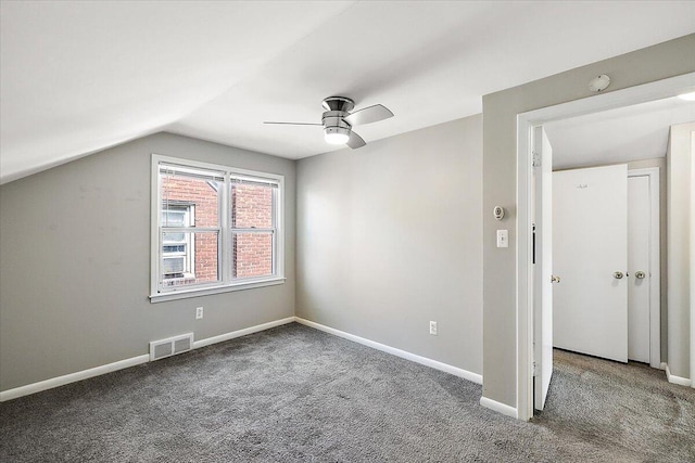 additional living space with ceiling fan, vaulted ceiling, and dark colored carpet