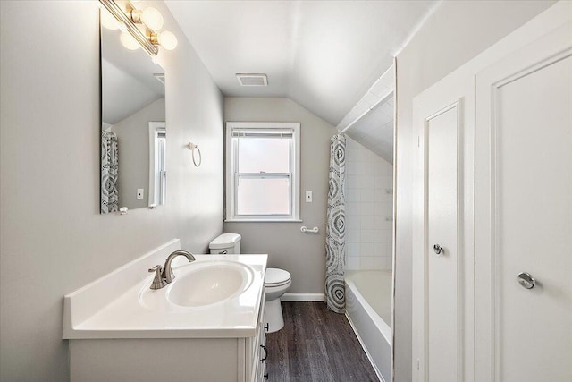 full bathroom with hardwood / wood-style floors, vaulted ceiling, toilet, shower / tub combo with curtain, and vanity