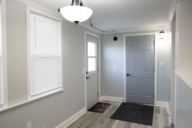 foyer featuring light hardwood / wood-style flooring and crown molding