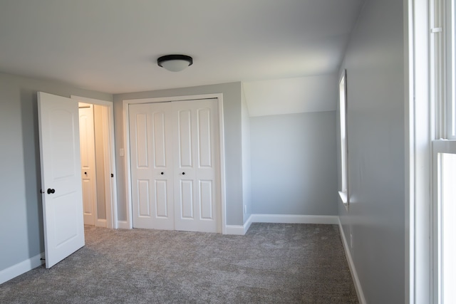 unfurnished bedroom featuring carpet floors and a closet