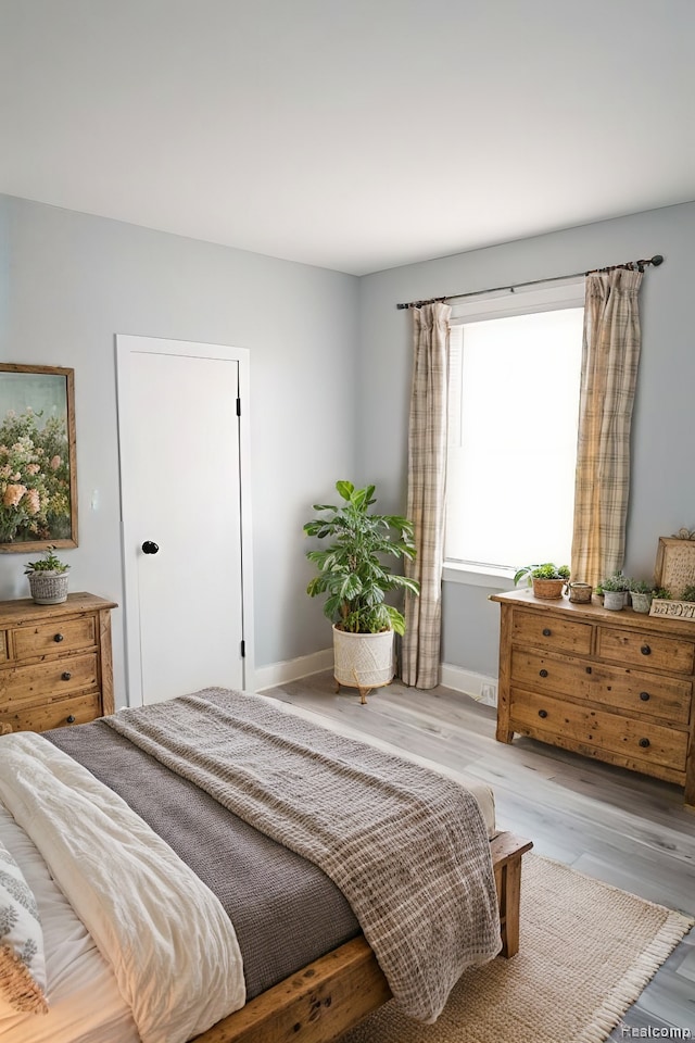 bedroom with light hardwood / wood-style flooring