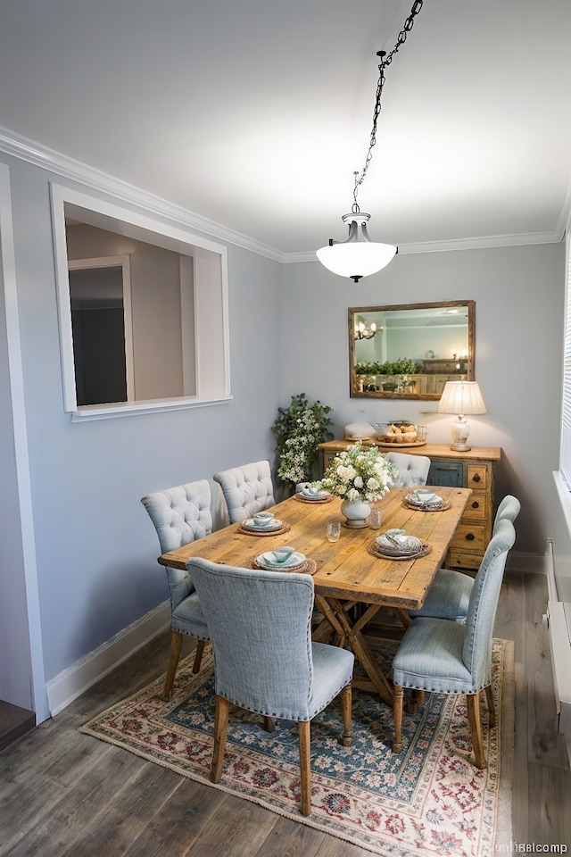 dining room with ornamental molding and dark wood-type flooring