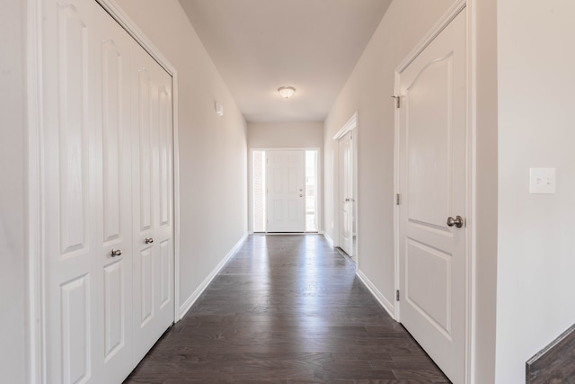 corridor with dark hardwood / wood-style flooring