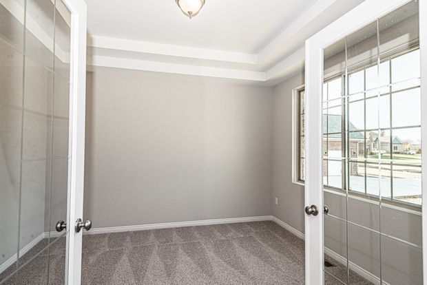 carpeted empty room featuring french doors