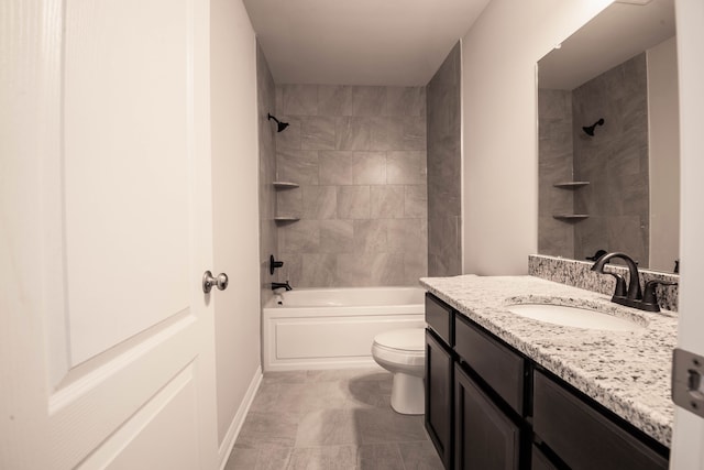 full bathroom featuring vanity, tiled shower / bath combo, and toilet