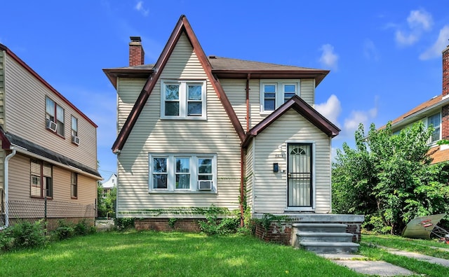 rear view of property with a lawn