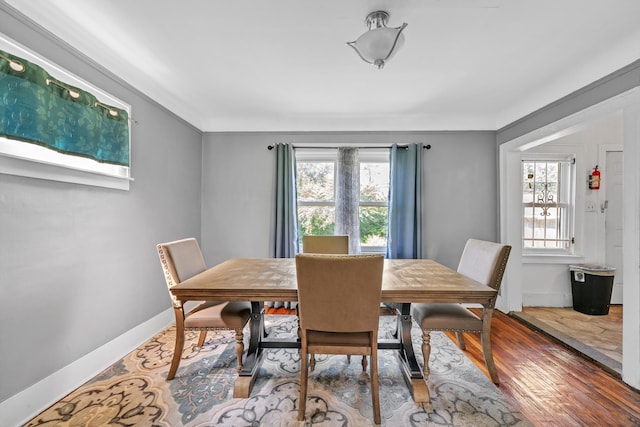 dining area featuring hardwood / wood-style flooring and a healthy amount of sunlight