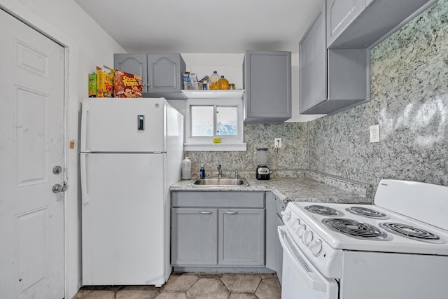 kitchen featuring backsplash, gray cabinetry, white appliances, sink, and light tile patterned floors