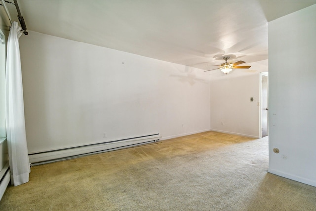 carpeted spare room with baseboard heating and ceiling fan